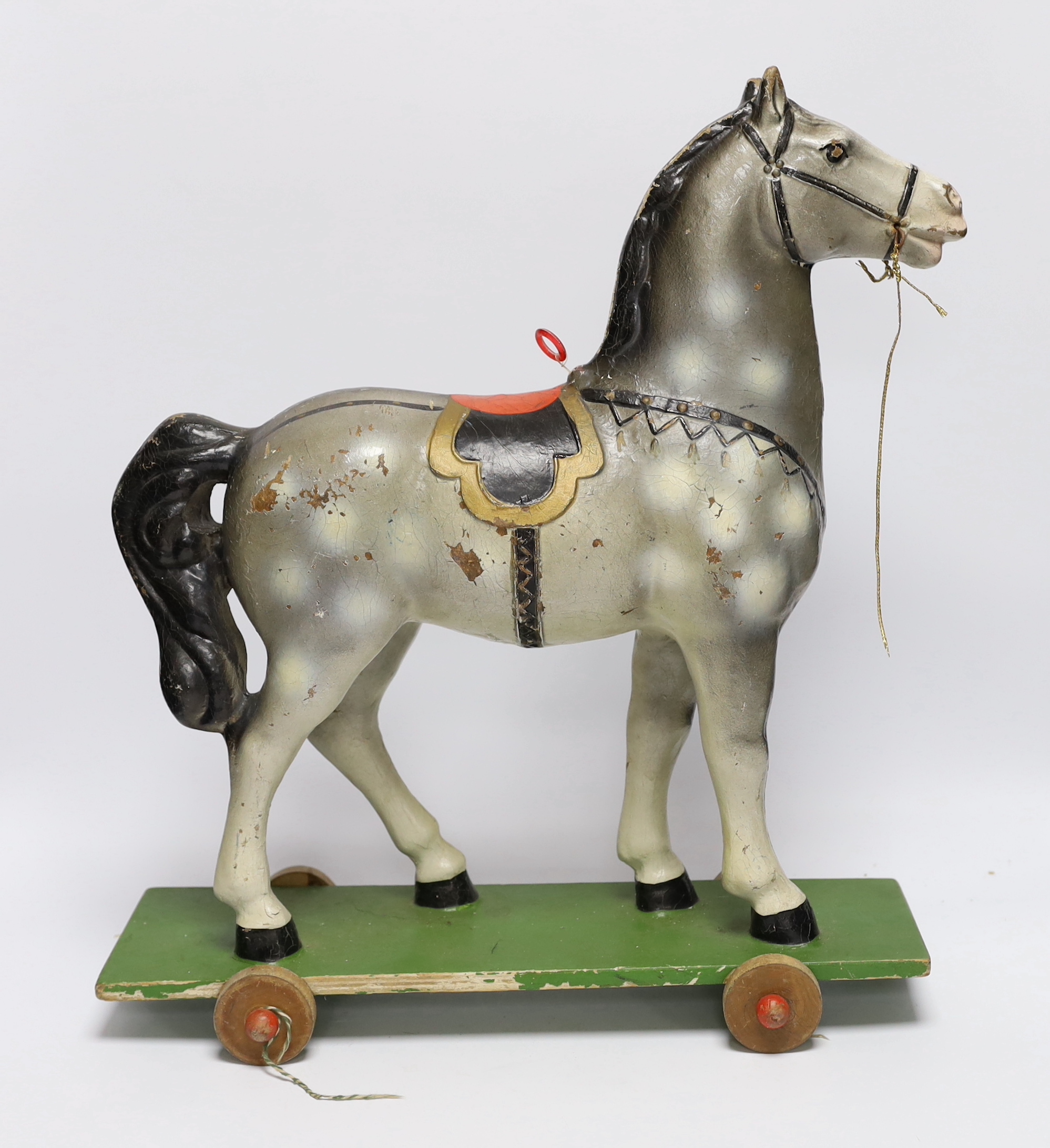 A push along vintage toy horse with pull-string soundbox, 47cm high